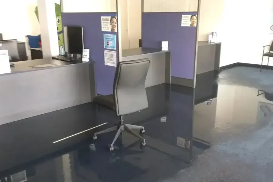 Standing water across the floor of a flooded office